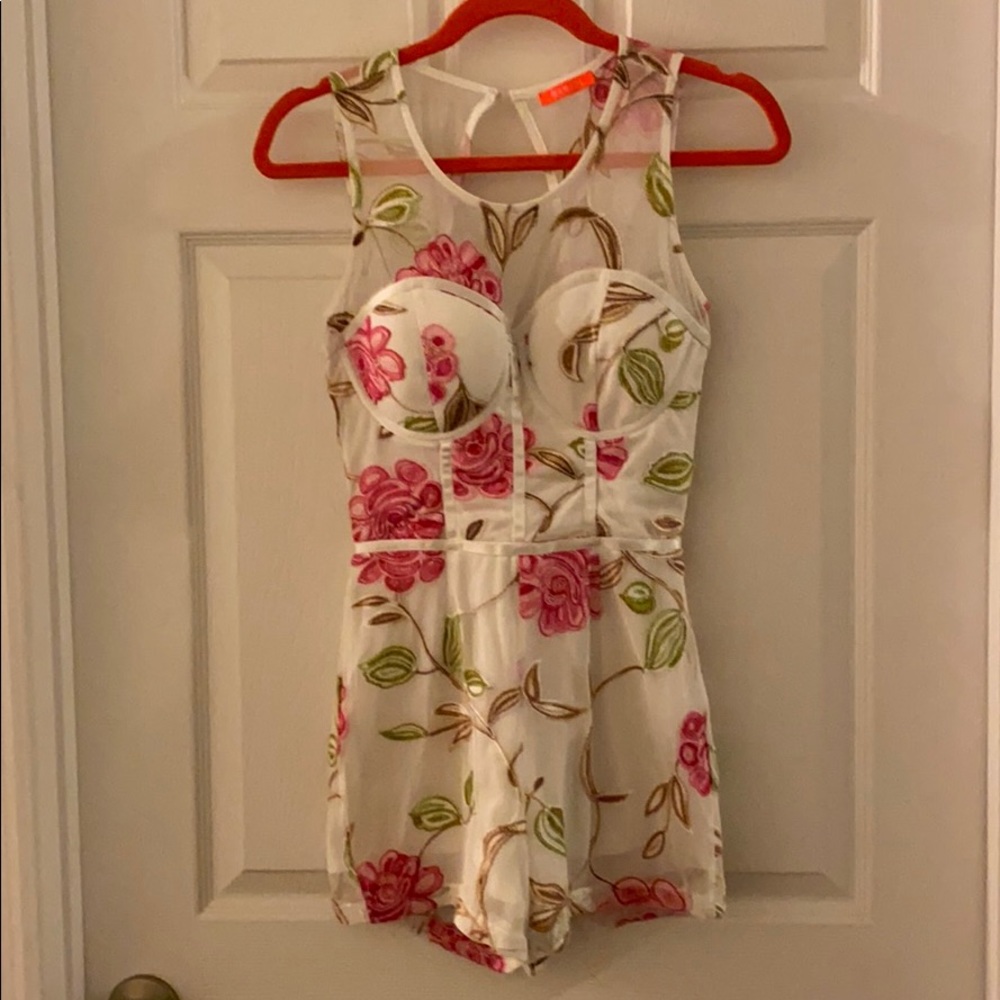 A white floral romper in excellent condition